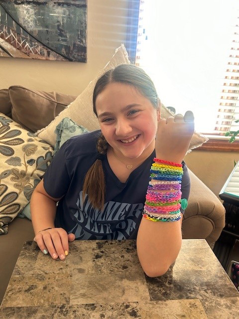 Kenzie, daughter of Presbyterian Assistant CRNA Director Jennifer Fleegle-Vitsas, models friendship bracelets sold at the lemonade fundraiser.