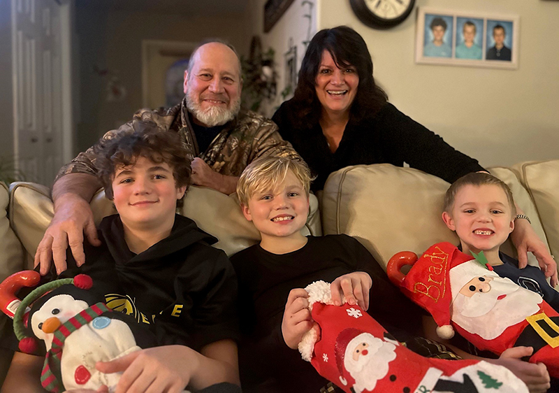 Dee and Jim with their grandkids, (L to R): Cooper, Parker, and Brady Trick