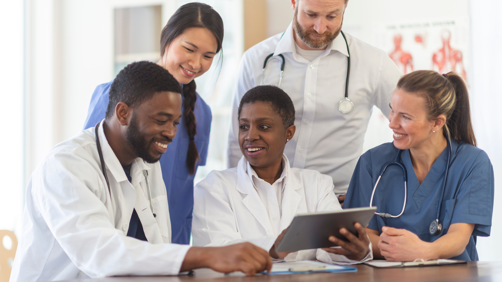 A group of physicians looking at a laptop