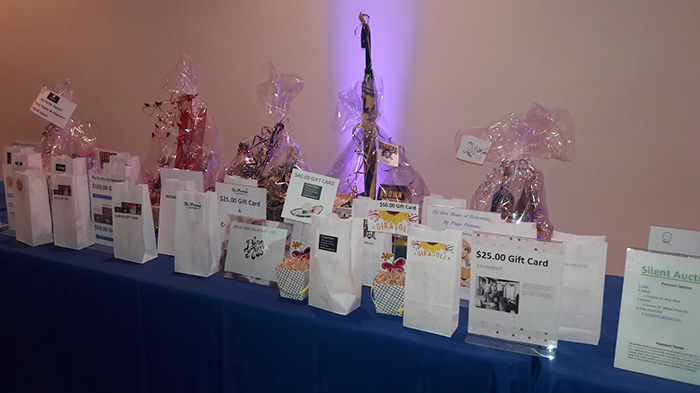 "A selection of gift bags and prizes sitting on top of a table"