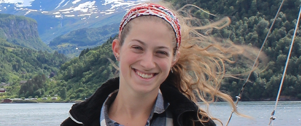 "Headshot of Annalisa Baratta with a backdrop of a lake and forests on a mountainside"