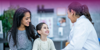 mother and daughter speaking with a female doctor