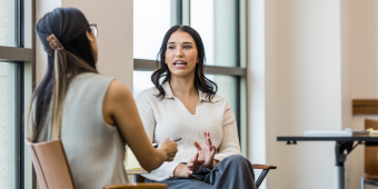 Photo of two people having a conversation